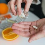 person holding vitamin pills - magnesium breakthrough